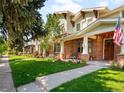 Inviting home exterior with a green lawn, manicured landscaping and covered front porch at 1265 S Sherman St, Denver, CO 80210