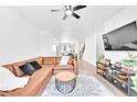 Spacious living room featuring wood floors and modern ceiling fan at 5387 Pierson Ct, Wheat Ridge, CO 80033