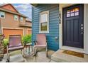 Quaint front porch with rocking chairs and a charming entryway at 10360 E 57Th Pl, Denver, CO 80238