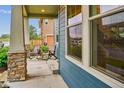 Relaxing front porch featuring stone pillars and space for seating at 10360 E 57Th Pl, Denver, CO 80238