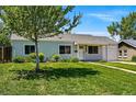 Traditional single-story home with lush front yard and a mature tree at 2751 S Elm St, Denver, CO 80222