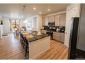 Modern kitchen with a large island, stainless steel appliances, and granite countertops at 1056 S Elk Way, Aurora, CO 80018
