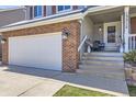 Charming two-story home featuring a brick facade, gray siding and a welcoming front porch at 13212 Clermont Cir, Thornton, CO 80241