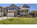 Charming two-story home with a well-manicured lawn and a welcoming front porch at 13212 Clermont Cir, Thornton, CO 80241