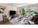 Cozy living room filled with natural light from large windows offering a comfortable space at 64 N Harlan St, Lakewood, CO 80226