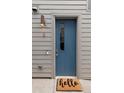 Stylish blue front door with glass inset, siding, and a welcoming 'hello' doormat at 1238 Quitman St # 2, Denver, CO 80204