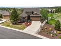 Aerial view of a well-maintained two-story home with a large driveway and mature landscaping in a suburban neighborhood at 7367 S Tempe Ct, Aurora, CO 80016