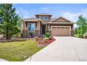 Charming home with attractive landscaping, stone accents, and a two-car garage at 7367 S Tempe Ct, Aurora, CO 80016