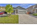 Charming two-story home with a well-maintained front yard and an attached two-car garage with a concrete driveway at 47349 Lily Ave, Bennett, CO 80102