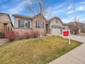Inviting home with a lush lawn and attractive landscaping at 10770 Hillrose St, Parker, CO 80134