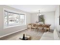 Inviting dining area with bay window, chandelier, and table for six at 3408 S Olathe Way, Aurora, CO 80013