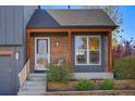 Inviting front porch with brick accents and wood trim, complementing the home's exterior at 11446 W 105Th Dr, Broomfield, CO 80021