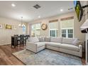 Spacious living room with L-shaped sofa, fireplace, and large windows at 2866 Low Meadow Blvd, Castle Rock, CO 80109