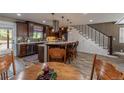 Beautiful kitchen with a large island, wood cabinets, pendant lighting, and stairs to a second floor at 10640 W 46Th Ave, Wheat Ridge, CO 80033