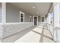 Inviting covered front porch with stone accents, windows, and plenty of natural light at 4046 N Irvington St, Aurora, CO 80019