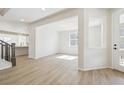 Bright living room featuring beautiful floors and an open layout to the kitchen at 4046 N Irvington St, Aurora, CO 80019
