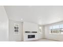 Living room with fireplace and large windows, creating a cozy and naturally lit space at 4046 N Irvington St, Aurora, CO 80019
