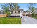Charming home with a covered front porch, with well maintained lawn and landscaping at 1960 S Franklin St, Denver, CO 80210
