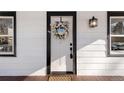Elegant white front door with a decorative wreath, black hardware, and sidelight window create a welcoming entrance at 1960 S Franklin St, Denver, CO 80210