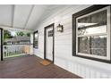 Inviting front porch with a classic white railing, and a wooden floor at 1960 S Franklin St, Denver, CO 80210