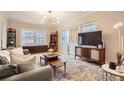 Comfortable living room with modern furnishings, a large TV, and bright natural light at 963 N Logan St # 11, Denver, CO 80203