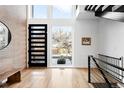 Bright entryway with hardwood floors, modern door and staircase at 3485 S Clermont St, Denver, CO 80222