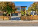 Modern two-story home with wood fence and attached garage at 3485 S Clermont St, Denver, CO 80222