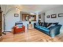 Inviting living room with stylish furniture and view into the kitchen at 12235 E Kentucky Ave, Aurora, CO 80012