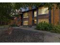 Townhouse exterior features wood siding, stone landscaping, and mature trees at 1231 S Crystal Way, Aurora, CO 80012