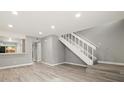 Living room showcasing wood floors, stairs, and a kitchen view at 1231 S Crystal Way, Aurora, CO 80012