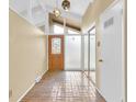 Bright foyer with a tiled floor, a decorative door, and unique stained glass pendant lighting at 2978 Robb Cir, Lakewood, CO 80215