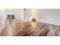 Living room with hardwood floors and access to a dining area at 3855 S Monaco St # 176, Denver, CO 80237