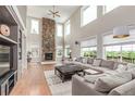 Spacious living room with stone fireplace and ample natural light at 8993 Stonecrest Way, Highlands Ranch, CO 80129