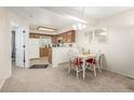 Bright dining area with a view of the kitchen, perfect for Gathering meals and entertaining at 1911 S Hannibal St # H, Aurora, CO 80013