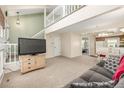Spacious living area with stairs, open floor plan, and view into the kitchen at 1911 S Hannibal St # H, Aurora, CO 80013