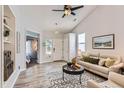 Bright living room with vaulted ceiling, modern furnishings, and wood-style flooring at 4868 Collingswood Dr, Highlands Ranch, CO 80130