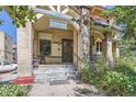 Close-up of the charming entrance featuring a detailed doorway, stone steps, and attractive landscaping at 1000 N Logan St, Denver, CO 80203