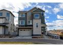 Two-story modern home with attached garage and light-grey siding at 11728 Octave Ave, Lone Tree, CO 80134