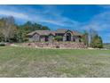 Beautiful exterior displaying a retaining wall, landscaped yard, and blue sky in the background at 19336 Queens Crescent Way, Monument, CO 80132