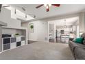 Open-concept living area showcases modern design, integrated shelving, and seamless access to the kitchen at 10438 Olathe Way, Commerce City, CO 80022