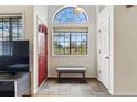 Welcoming foyer with high ceilings, slate flooring, bench seating, and large windows to outside at 3105 Galileo Ln, Boulder, CO 80301
