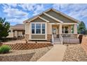 Charming single-Gathering home with manicured landscaping, stone accents, and welcoming front porch at 5603 Van Bibber Ct, Golden, CO 80403