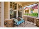 Inviting front porch features a comfortable bench, offering a relaxing outdoor space at 5603 Van Bibber Ct, Golden, CO 80403