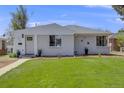 Charming single-story home with a well-manicured lawn and inviting front entrance at 903 Poplar St, Denver, CO 80220