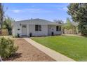 Charming single-story home with a well-manicured lawn and inviting front entrance at 903 Poplar St, Denver, CO 80220