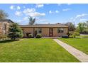 Charming single-story home featuring a well-maintained lawn and inviting walkway to front door at 998 S Leyden St, Denver, CO 80224