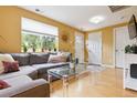 Bright living room with a large window, modern decor, and a comfortable gray sectional sofa at 998 S Leyden St, Denver, CO 80224