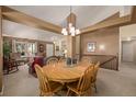 Bright dining area with wood table and chairs, open to living room at 1429 S Grand Baker Cir, Aurora, CO 80018