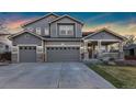 Spacious two-story home featuring a three-car garage and inviting covered porch, perfect for Gathering living at 1831 Ashford Cir, Longmont, CO 80504