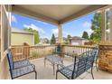 Cozy covered front porch featuring comfortable seating and views of the neighborhood at 1831 Ashford Cir, Longmont, CO 80504